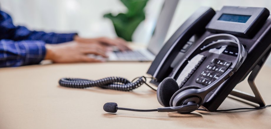 Communication support, call center and customer service help desk. telephone devices with VOIP headset in office.Customer service support (call center) concept.
